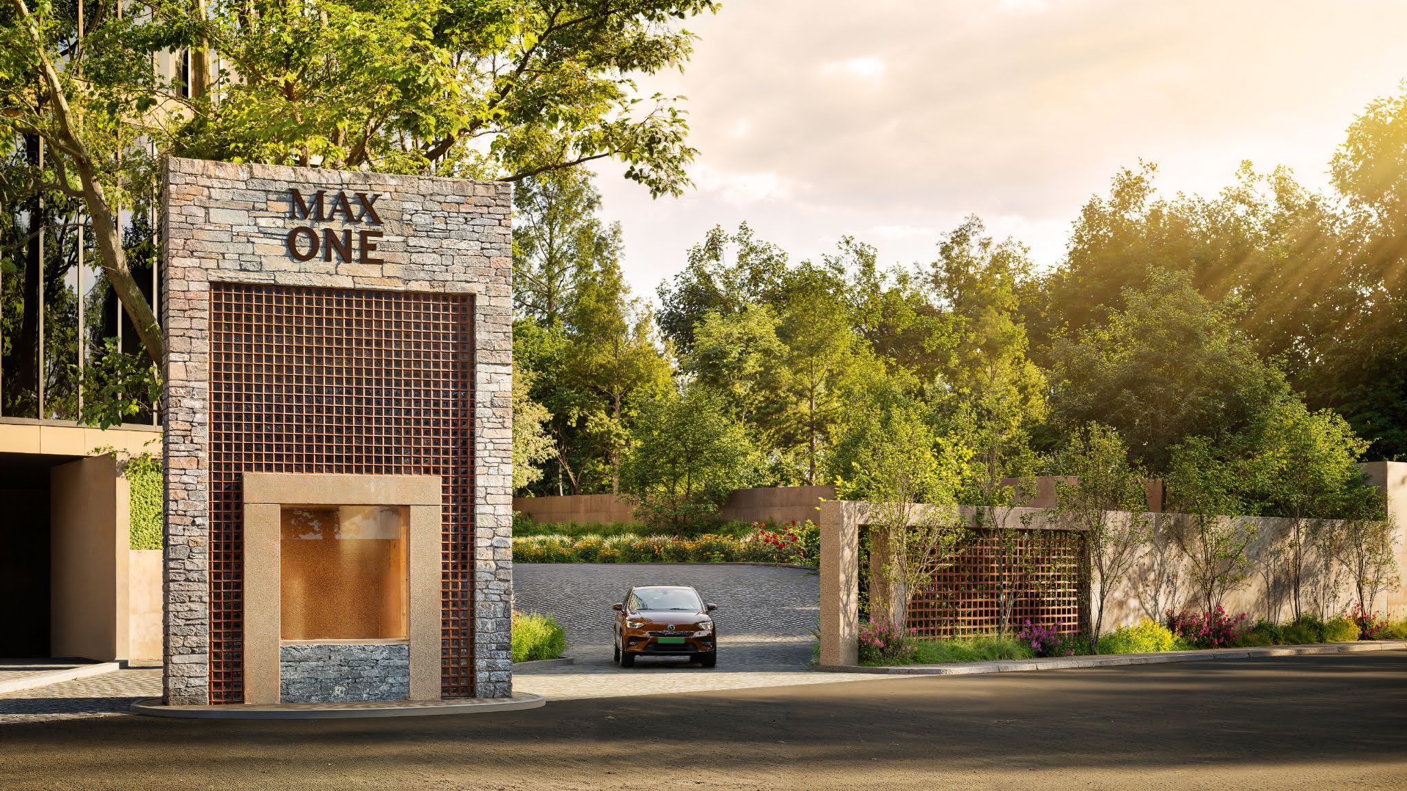 Driveway entrance at Max One residential towers with landscaped greenery and modern building facade